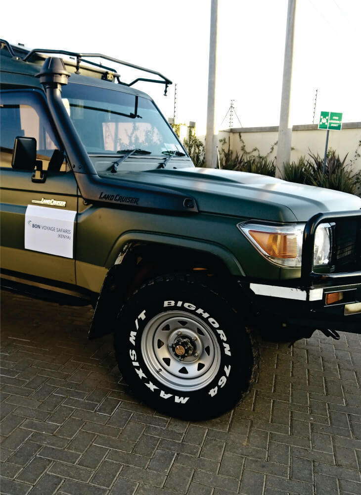 front part of custom-built 4x4 green jeep with suspension system and the front axle in Amboseli on private Africa jeep safari tours