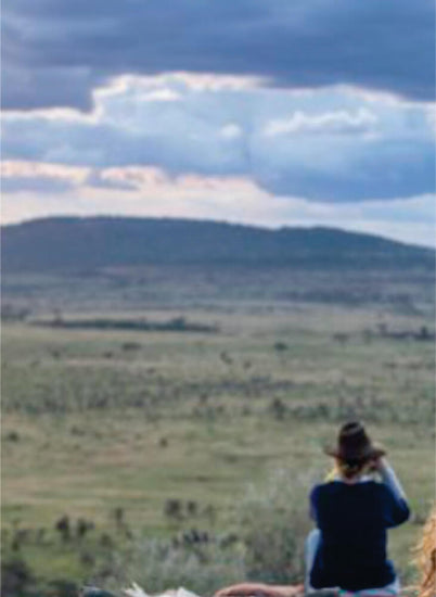 Man photographing on field in Masai Mara on luxury Mara Serena Safari Lodge Masai Mara group tour