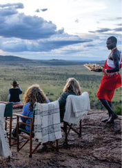 three people enjoying a unique dining experience at a Sundowner on luxury Mara Serena Safari Lodge Masai Mara group tour